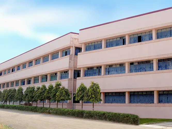 A long three-storey academic building on the campus
