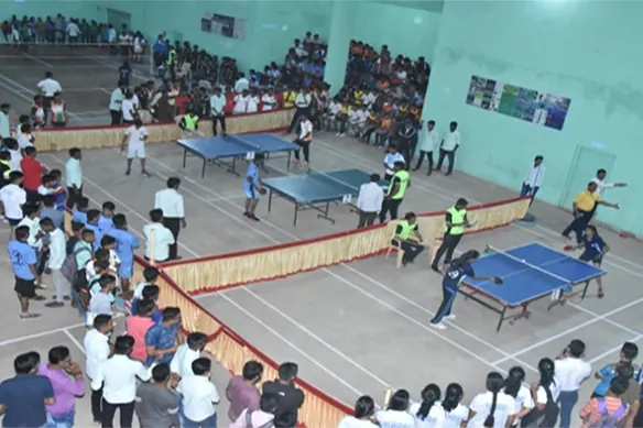 Players and spectators at an indoor table-tennis competition in a sports hall