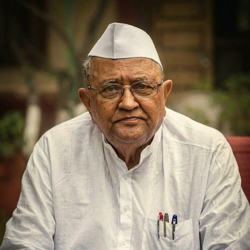 Colour portrait of Annasaheb P. K. Patil in a white cap, glasses and white khadi shirt