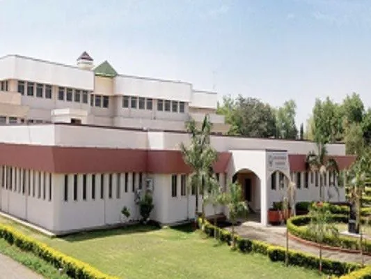D. N. Patel College of Engineering, a white building with an arched entrance and gardens